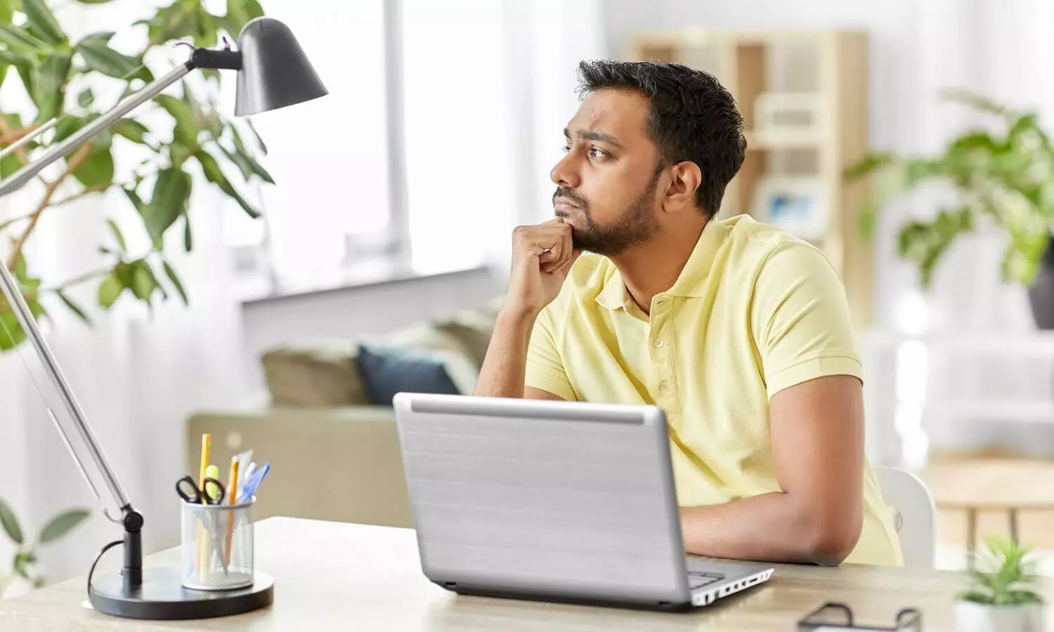 Indian Man with Laptop Thinking at Home Office
