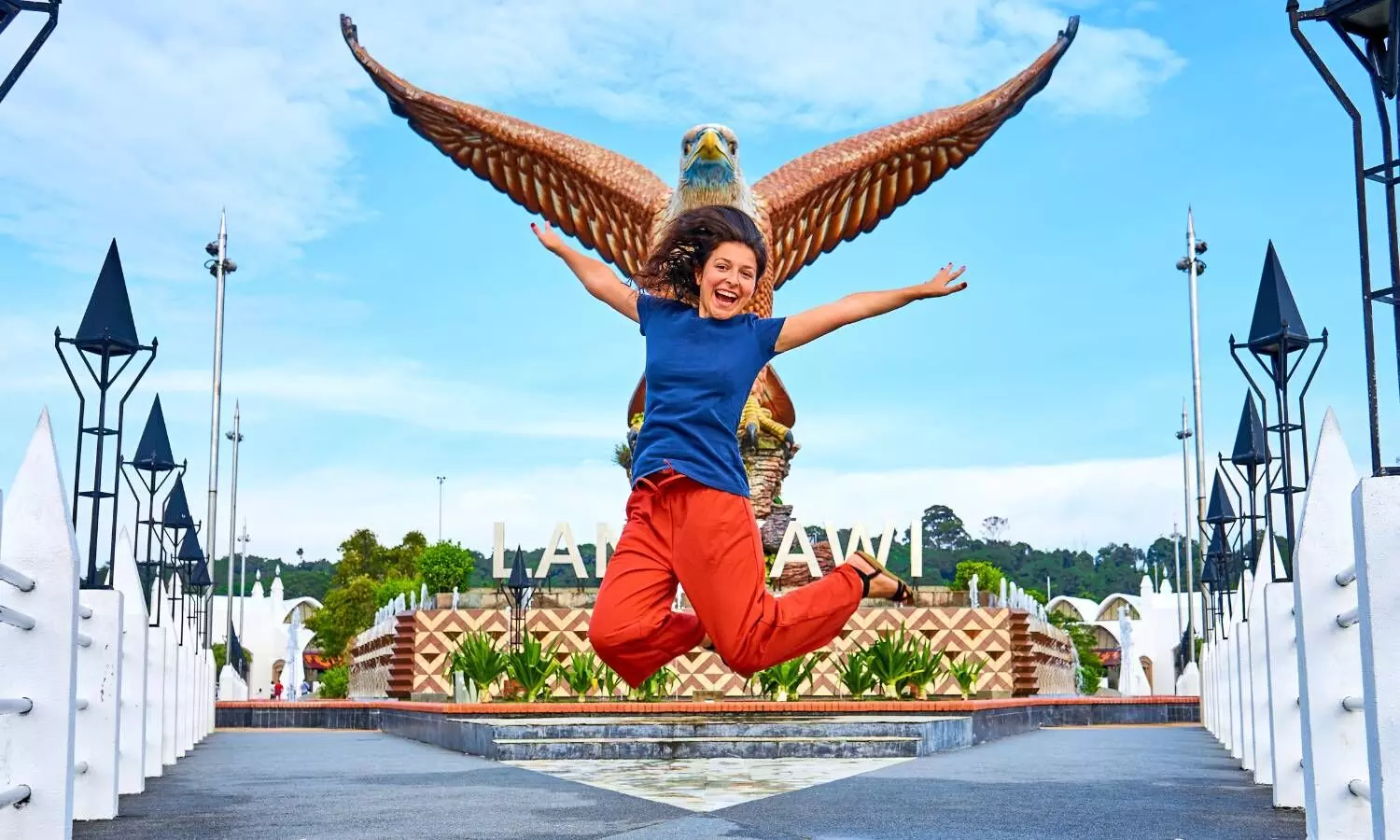 Female Tourist Posing Next to an Eagle Sculpture in Langkawi