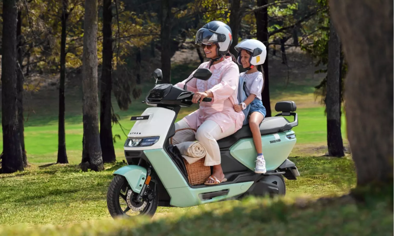 A mother and child riding travelling on an Ather Rizta electric scooter