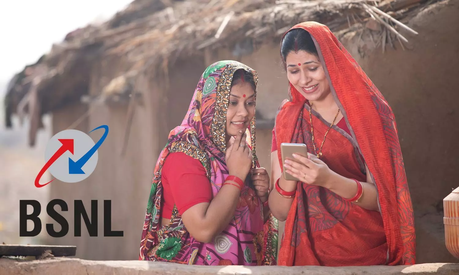 Indian women look at phone, BSNL Logo