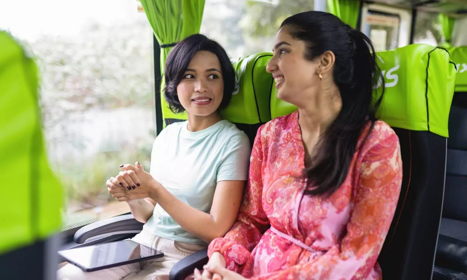 two women travelling on  a bus