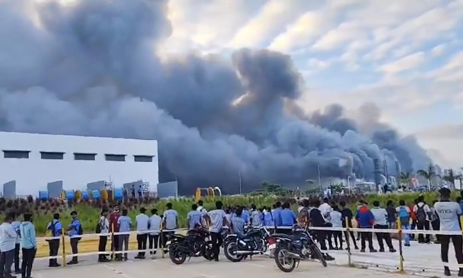 Tata Electronics Hosur Plant engulfed in flames, with smoke billowing into the air