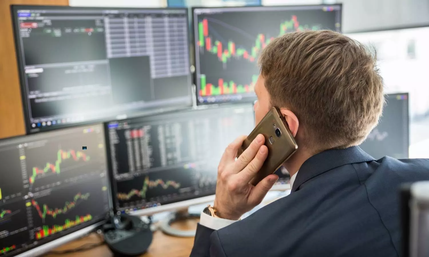 a stock market broker speaking over a phone