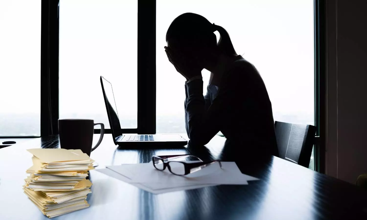 a woman sitting on the chair in front of computer